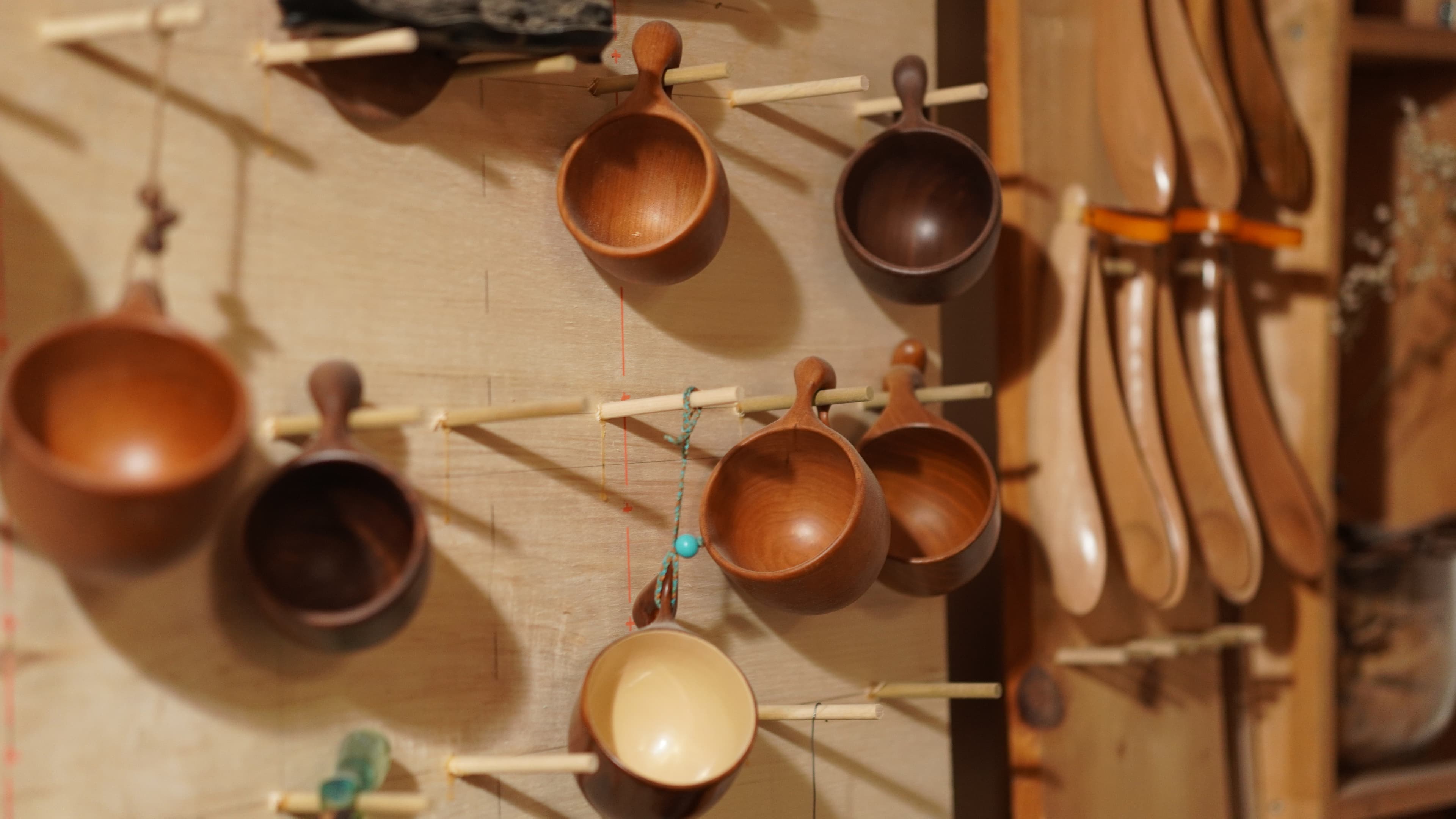 Wooden cups displayed on a wall
