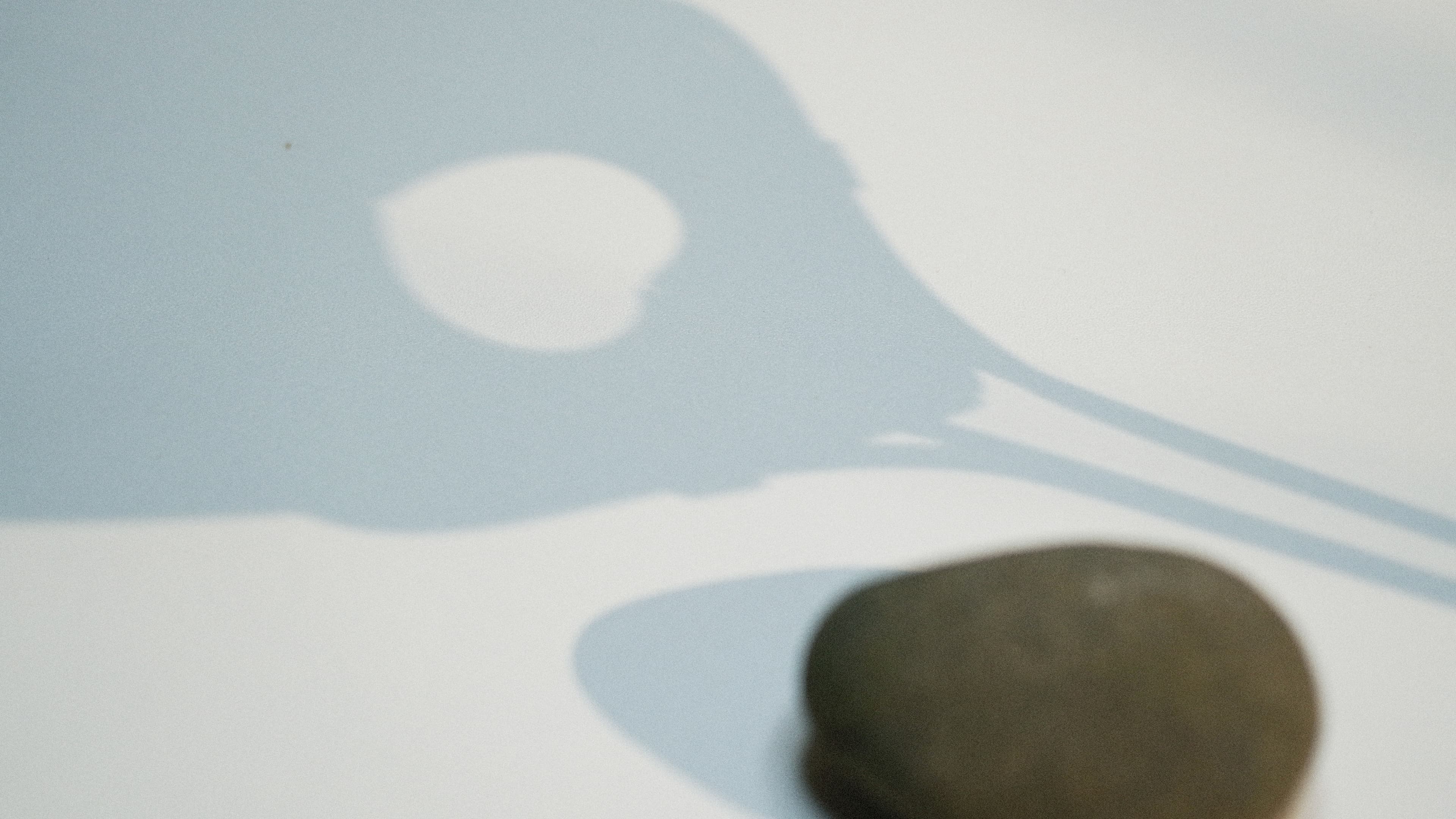 Shadow of a kuksa cast on a pale surface